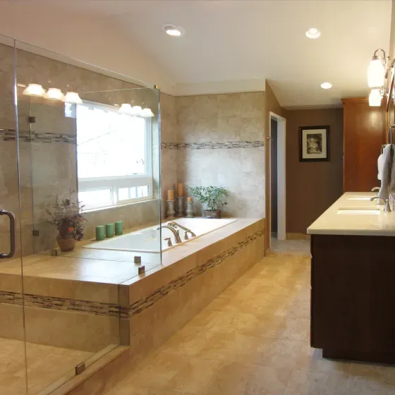 A bathroom with two sinks and a large tub