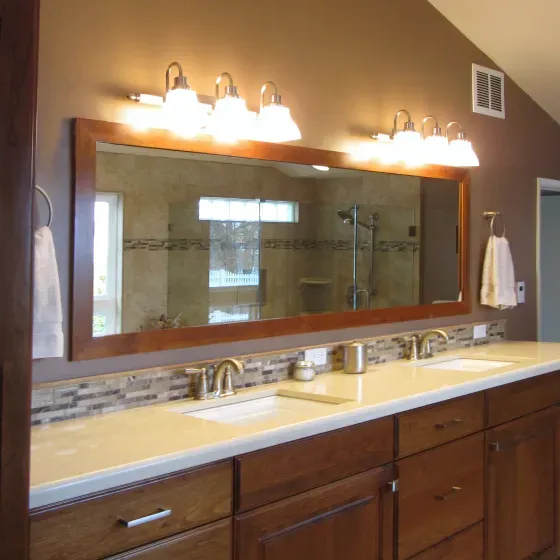 A bathroom with two sinks and a large mirror