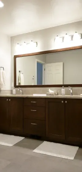 A bathroom with two sinks and a large mirror