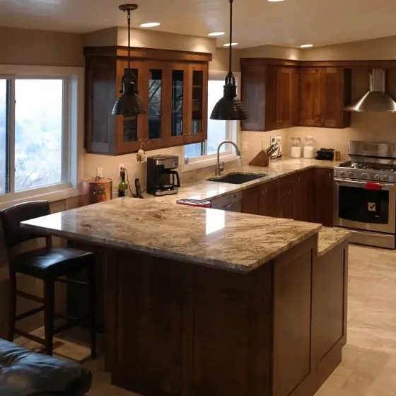 A kitchen with granite counter tops and wooden cabinets