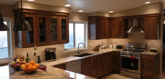 A kitchen with stainless steel appliances and wooden cabinets.
