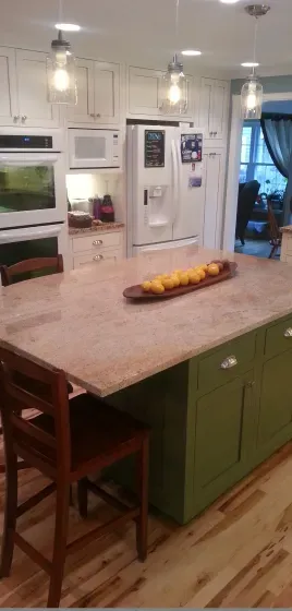 A kitchen with a large island and a tray of fruit on it