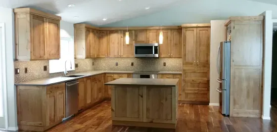 A kitchen with wooden cabinets and stainless steel appliances