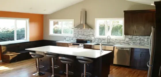 A kitchen with a large island and stools