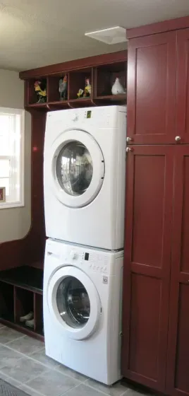 A washer and dryer are stacked on top of each other in a laundry room.