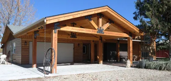 A house with a wooden garage and a porch