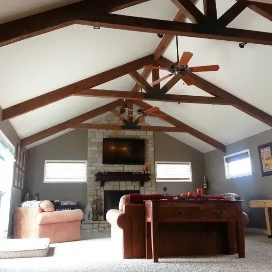 A living room with a ceiling fan and a fireplace