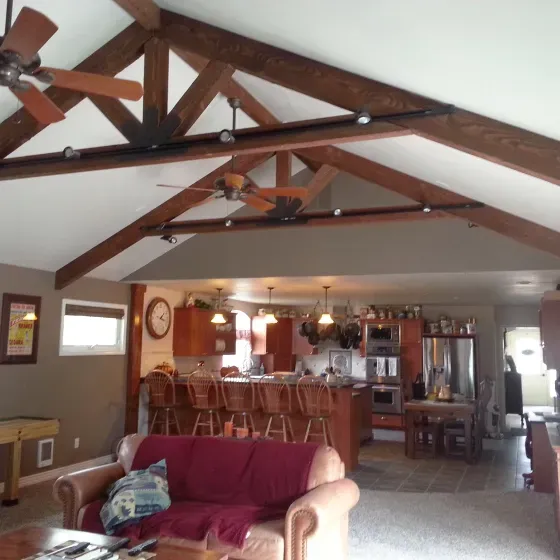 A living room with a couch and a ceiling fan