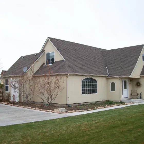 A large house with a brown roof and a lot of windows