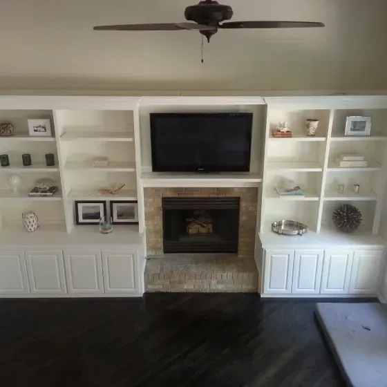 A living room with a fireplace and a flat screen tv