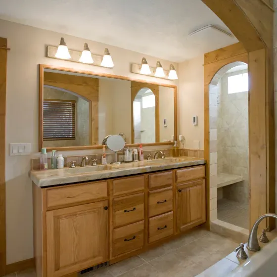 A bathroom with two sinks and a large mirror