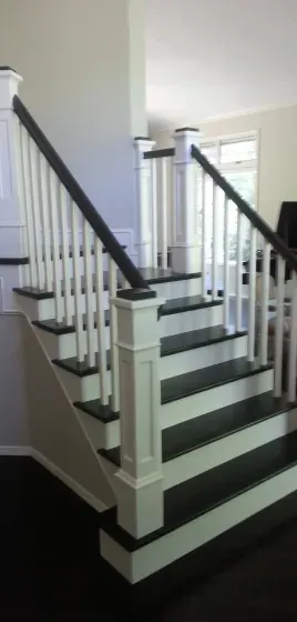 A white staircase with black steps and a black railing