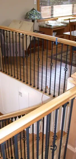 A view of a staircase from the second floor of a house.