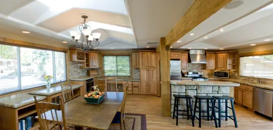A kitchen with a table and chairs in it