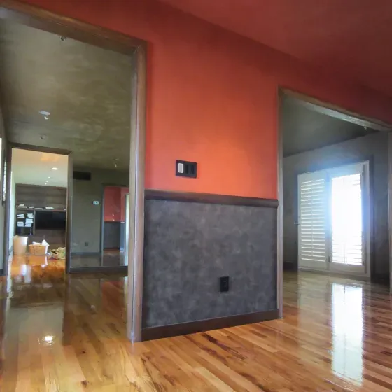 A room with hardwood floors and red walls