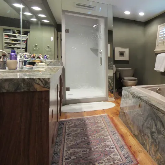 A bathroom with a walk in shower and a bathtub