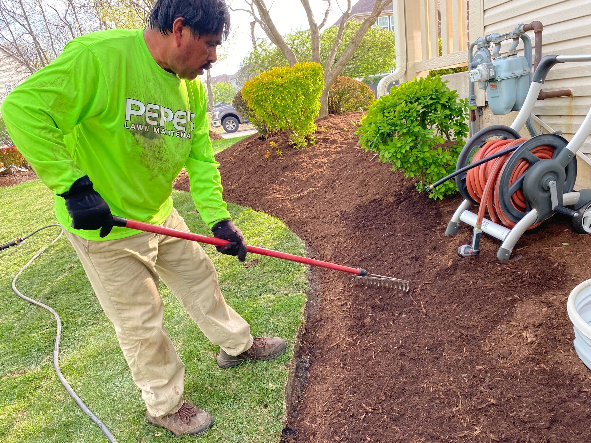 A person is holding a pile of mulch in their hands.