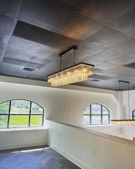 Electrician installed chandelier in commercial building