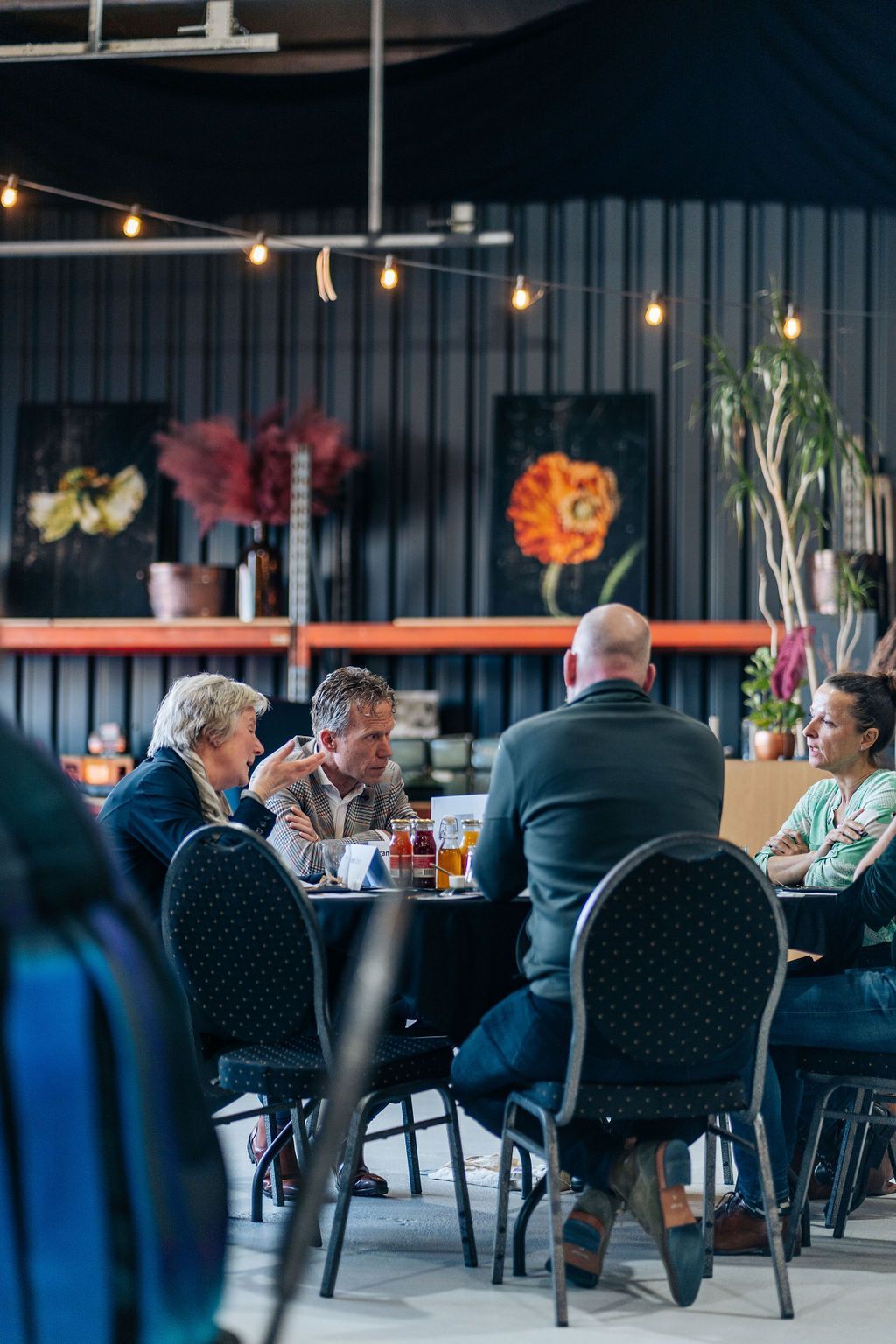 In een restaurant zit een groep mensen aan tafel.