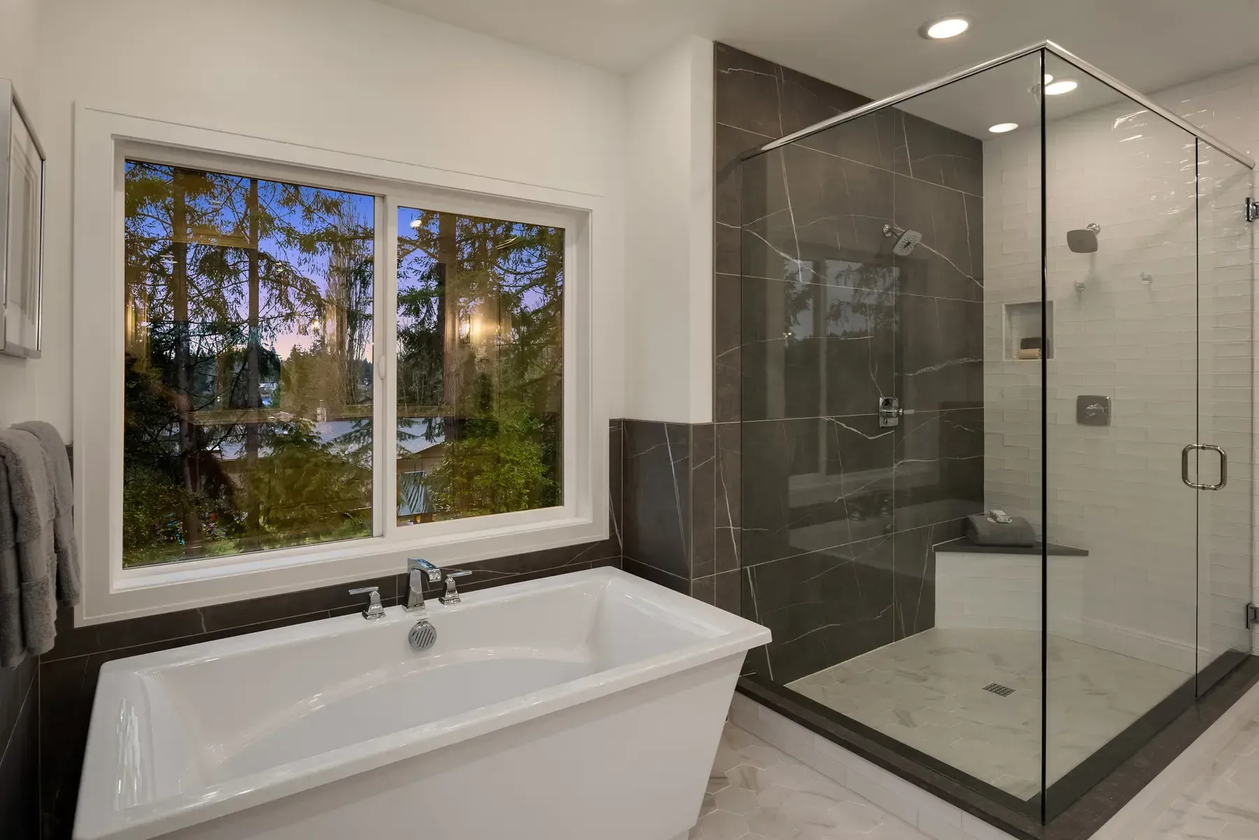 A bathroom with a tub and a walk in shower.