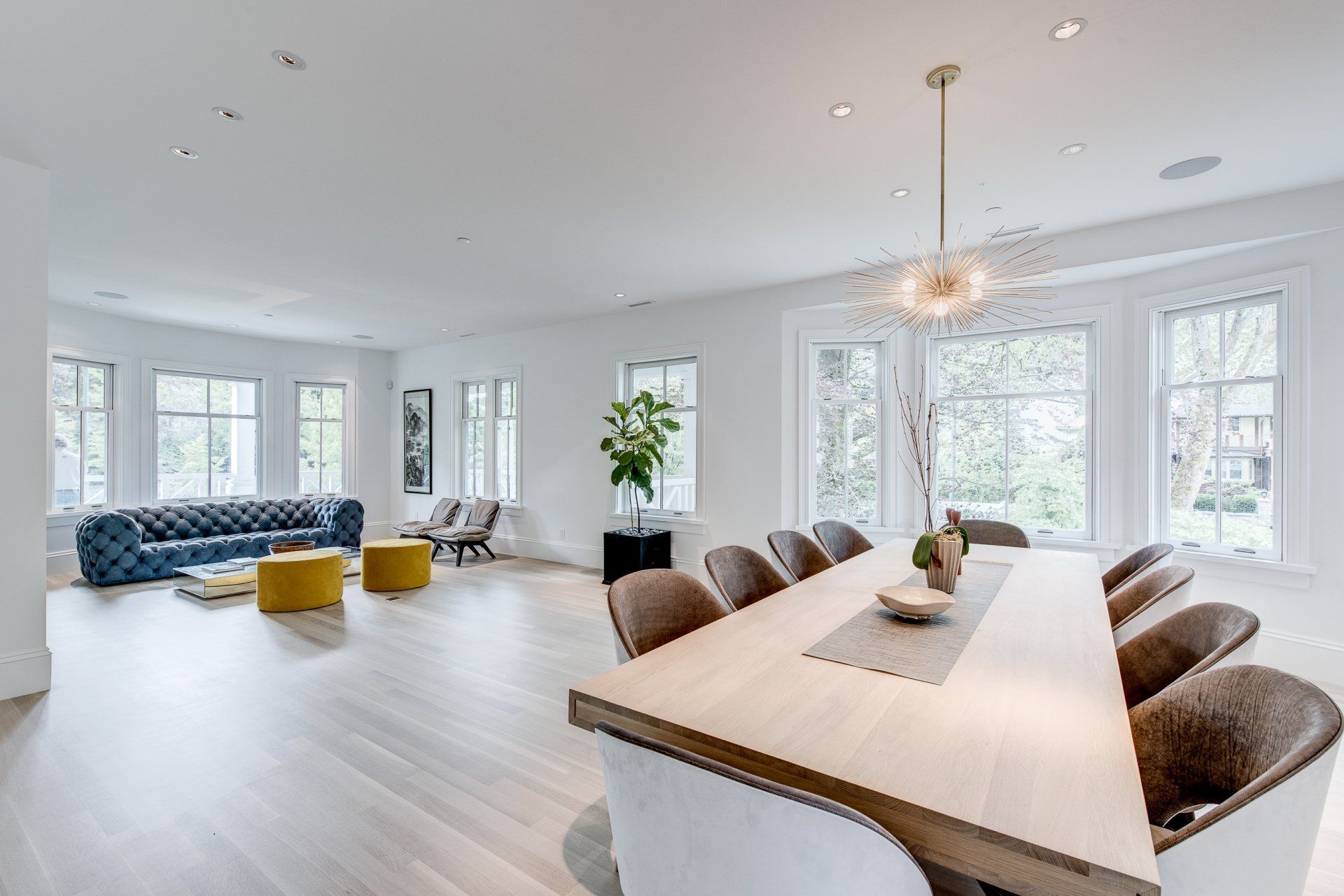 A large living room with a dining table and chairs.