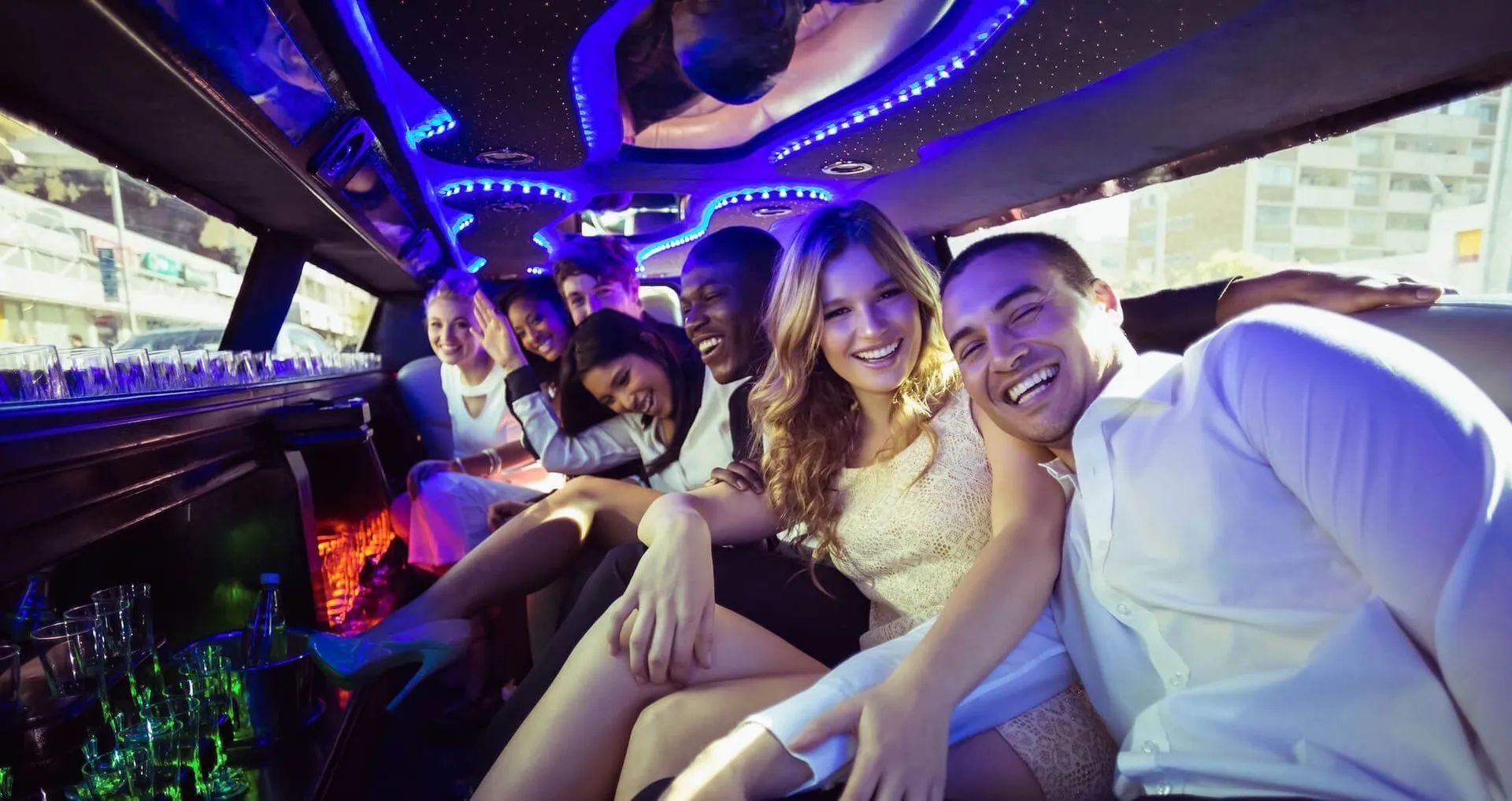 A group of people are sitting in a limousine.