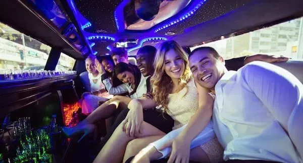 A group of people are sitting in a limousine.