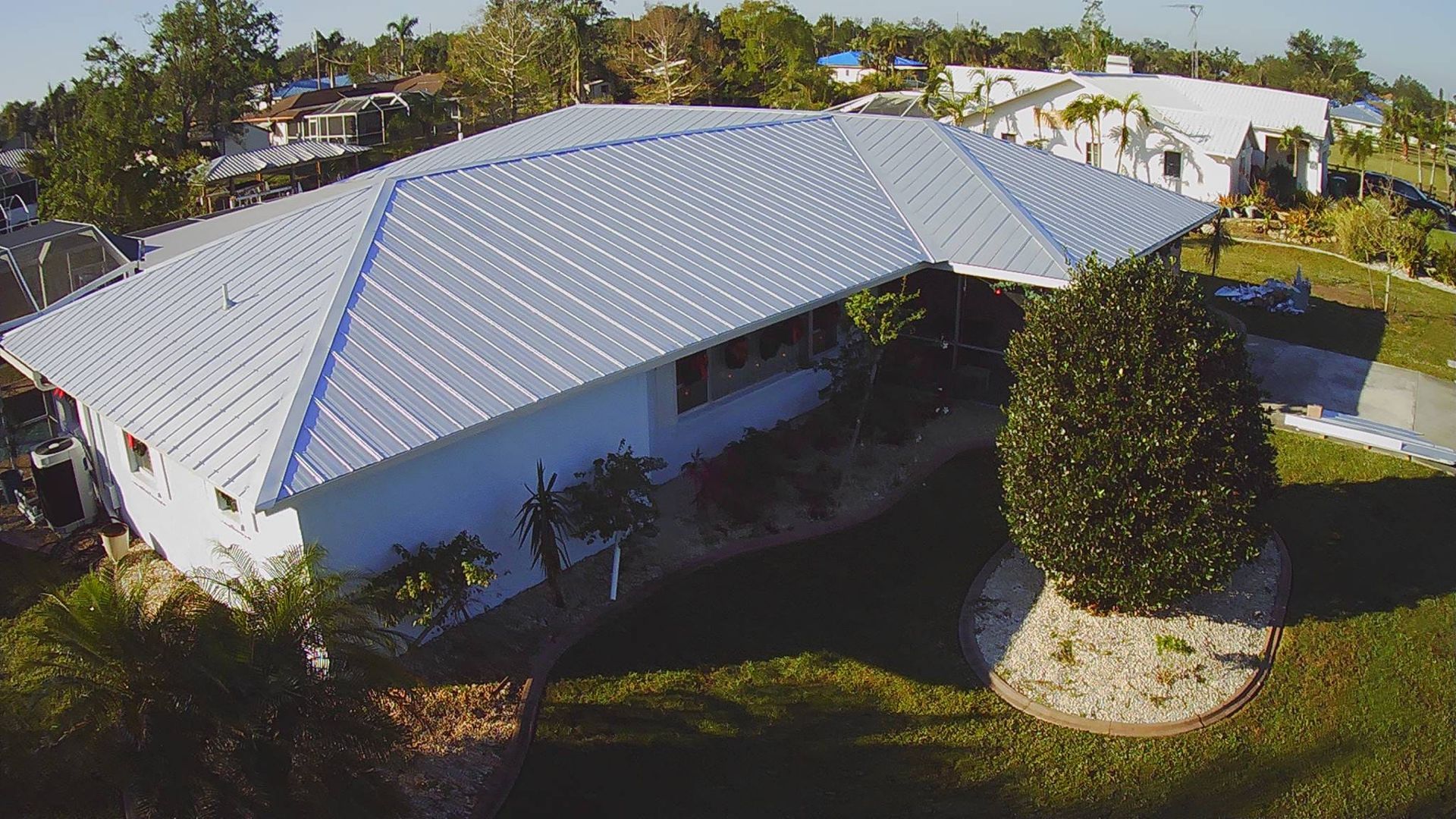 Man Using Electric Drill On The Roof — Cape Coral, FL — FLORIDA'S FAVORITE ROOFER