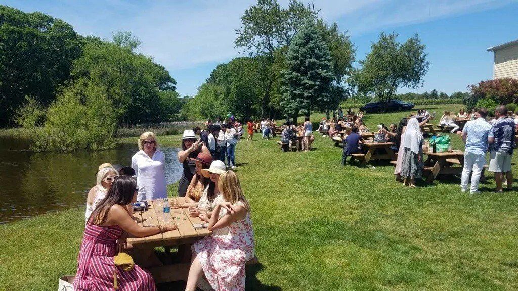 East End Wine Tasting Tours at 
Pugliese Vineyard picnic tables by the pond