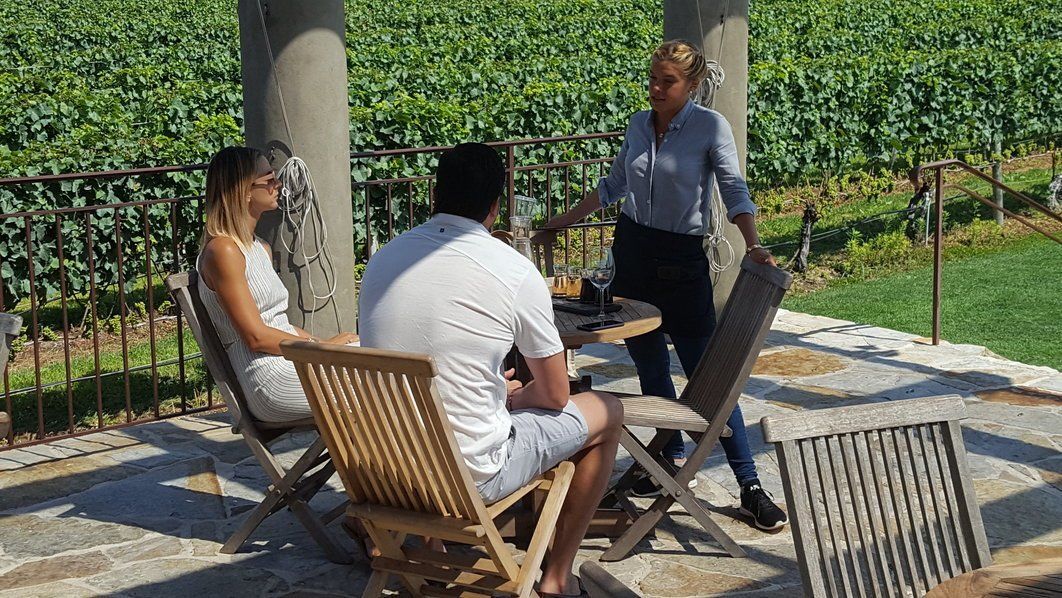 East End Wine Tasting Tours Wolffer Estate Rear Patio and Table for a Couple celebrating