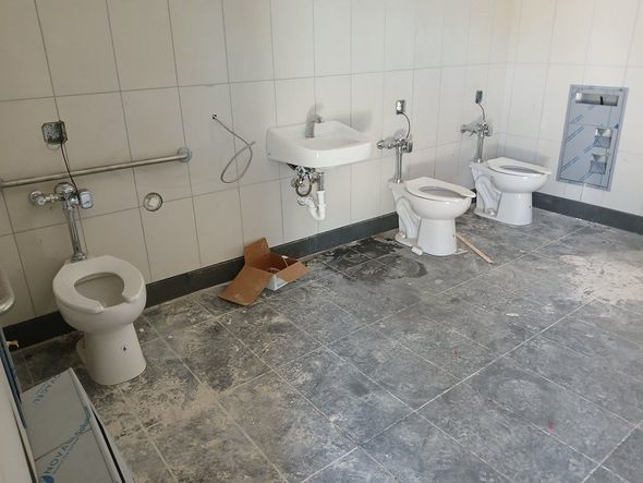 A person is washing their hands in a bathroom sink.