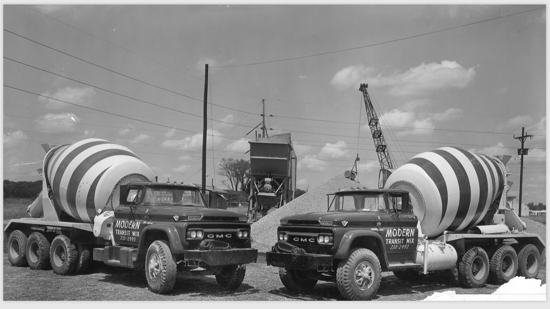 A mcqueen concrete mixer truck is parked on the side of the road