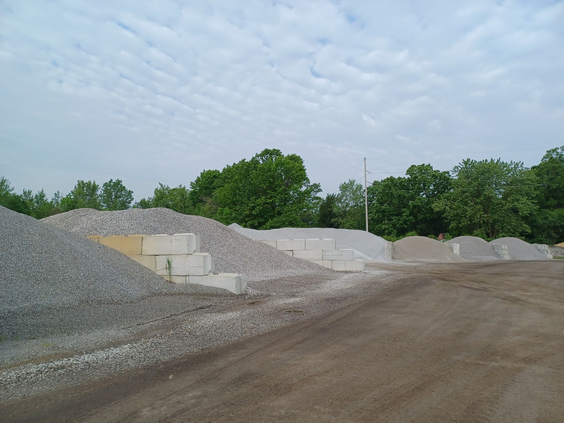 A pile of rocks with a cloudy sky in the background