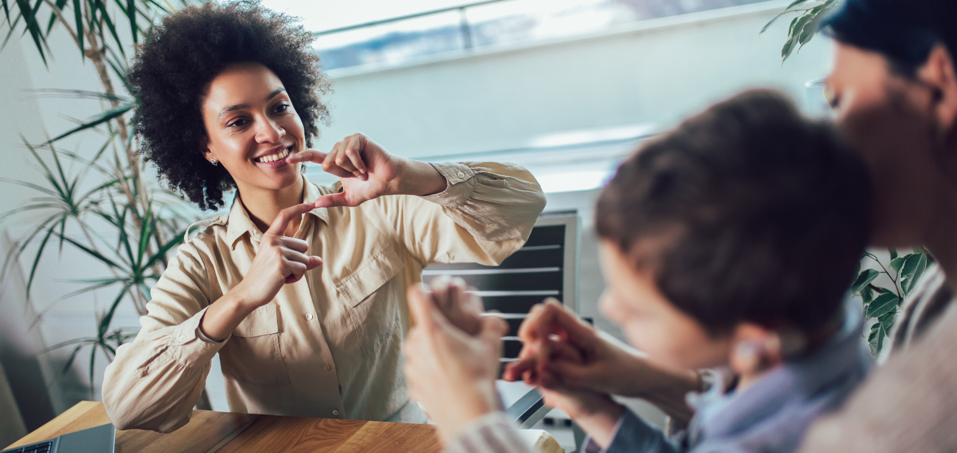 woman doing sign language to boy