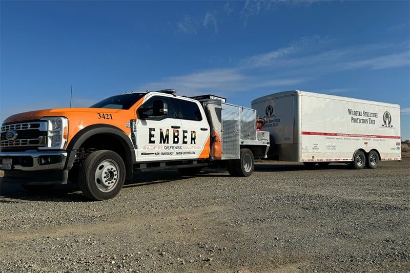 A truck is pulling a Wildfire Structure Protection trailer.