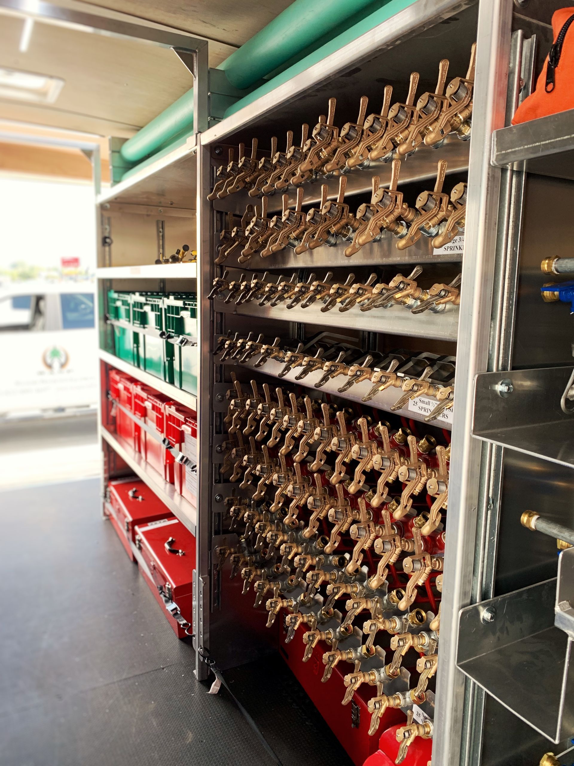 A row of shelves filled with a variety of tools in a Structure Protection Trailer.