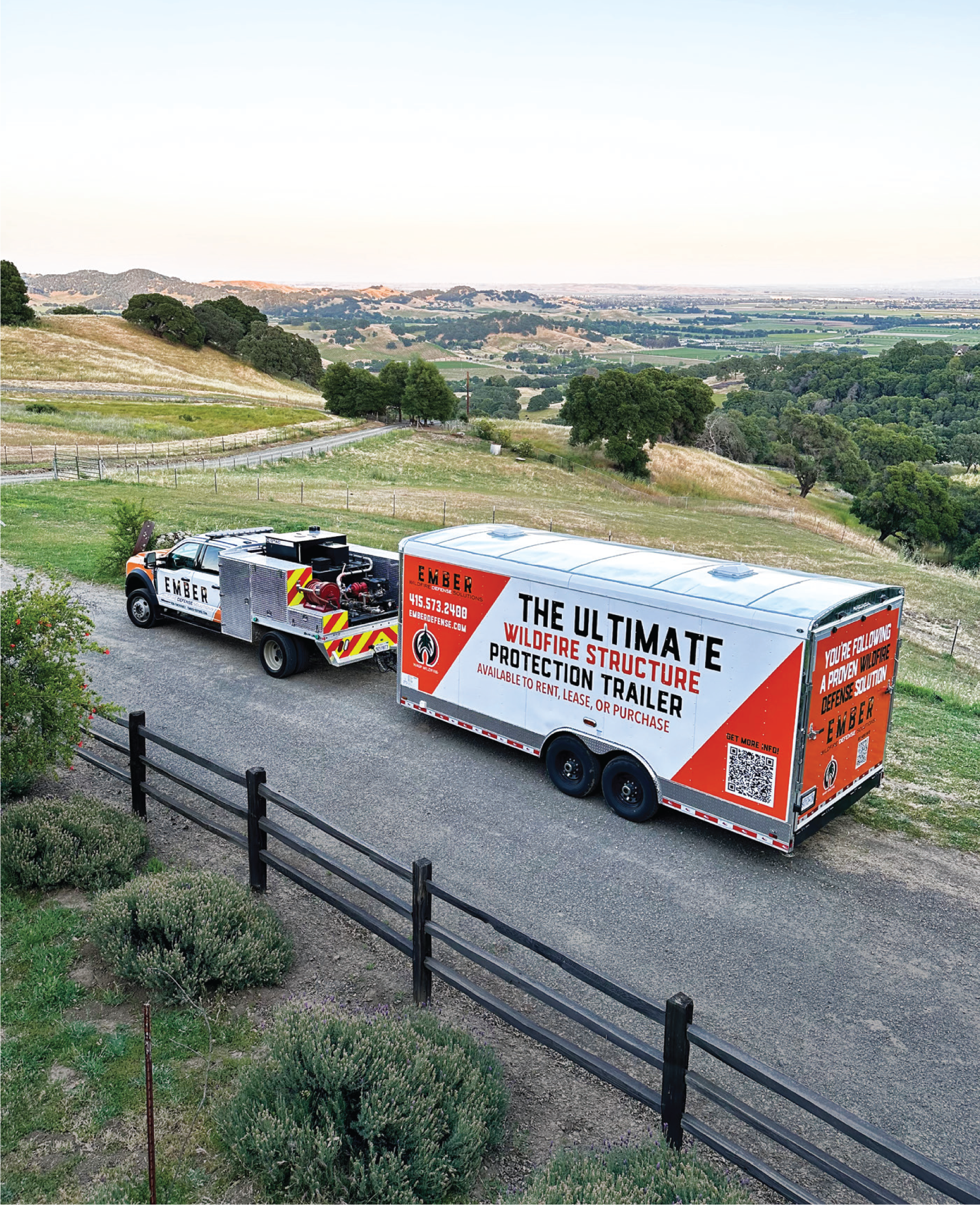 A truck is pulling a Wildfire Structure Protection trailer down a road.
