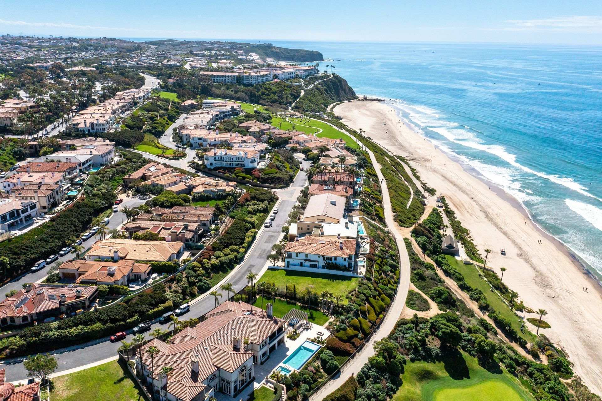 An aerial view of a residential area next to a beach.