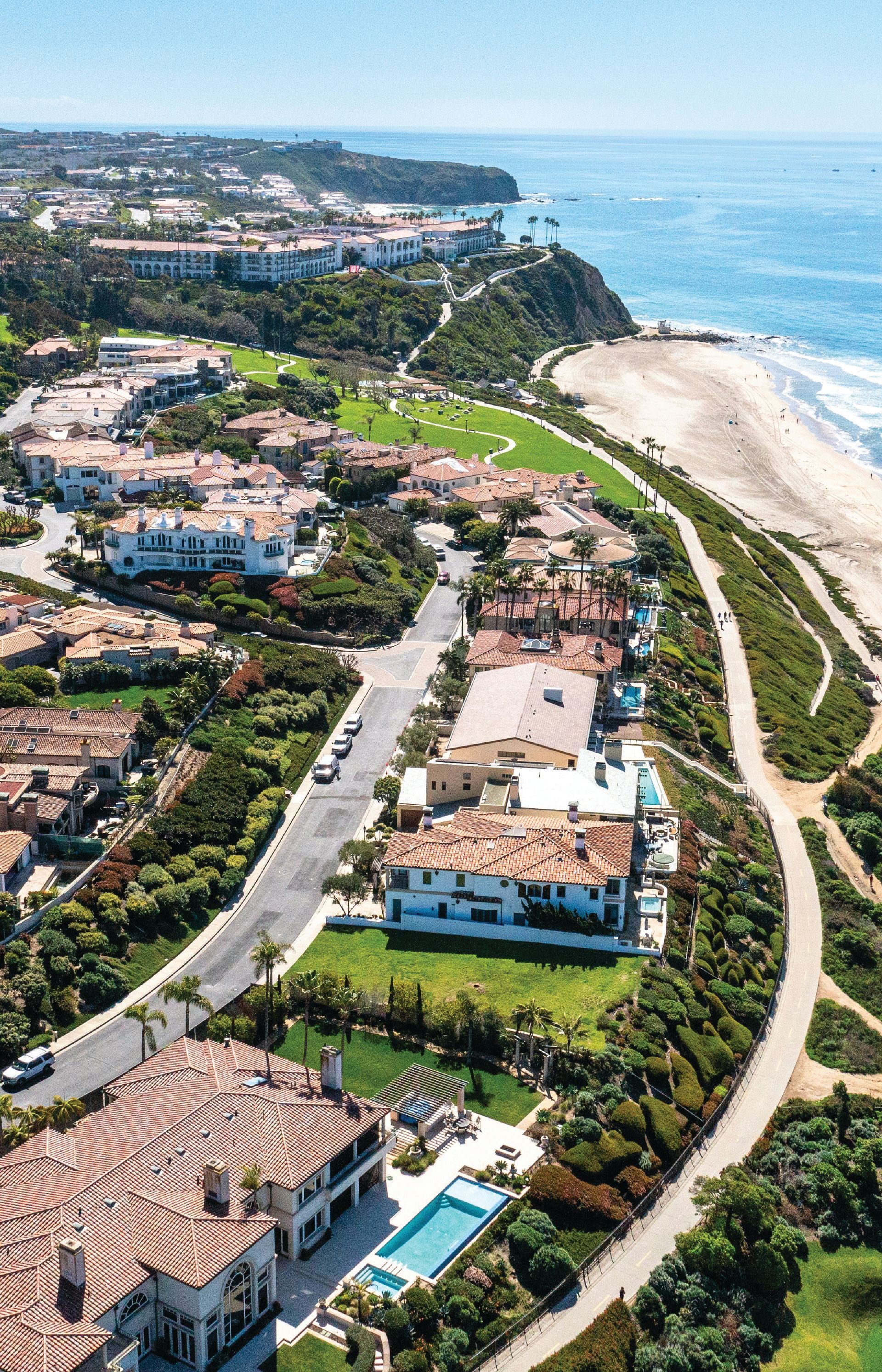 An aerial view of a residential area next to the ocean.