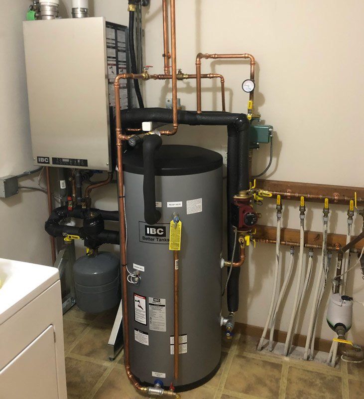 HVAC system in a utility room with a water heater, pipes, and a boiler. Beige walls and tiled floor.