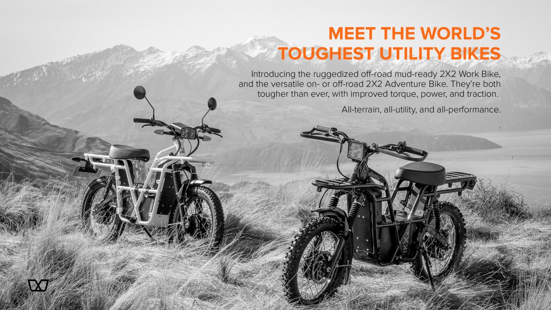 A black and white photo of two motorcycles on top of a hill.
