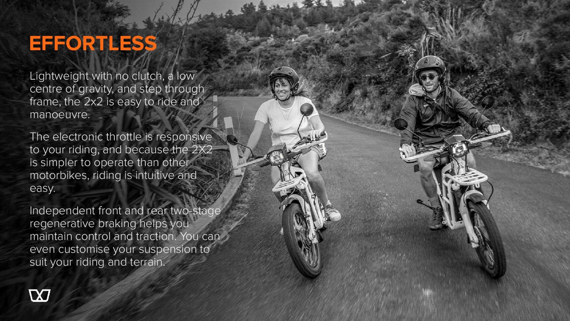 Two people are riding motorcycles down a road.