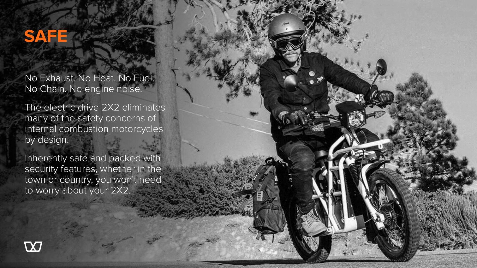 A man is riding a motorcycle on a dirt road.