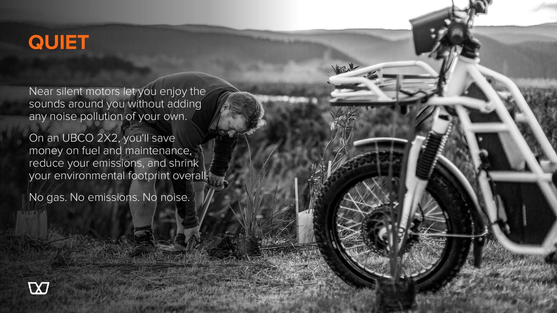 A black and white photo of a bicycle parked in a field.