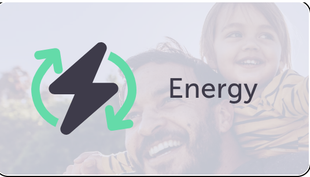 A man and a child are smiling in front of a sign that says energy.