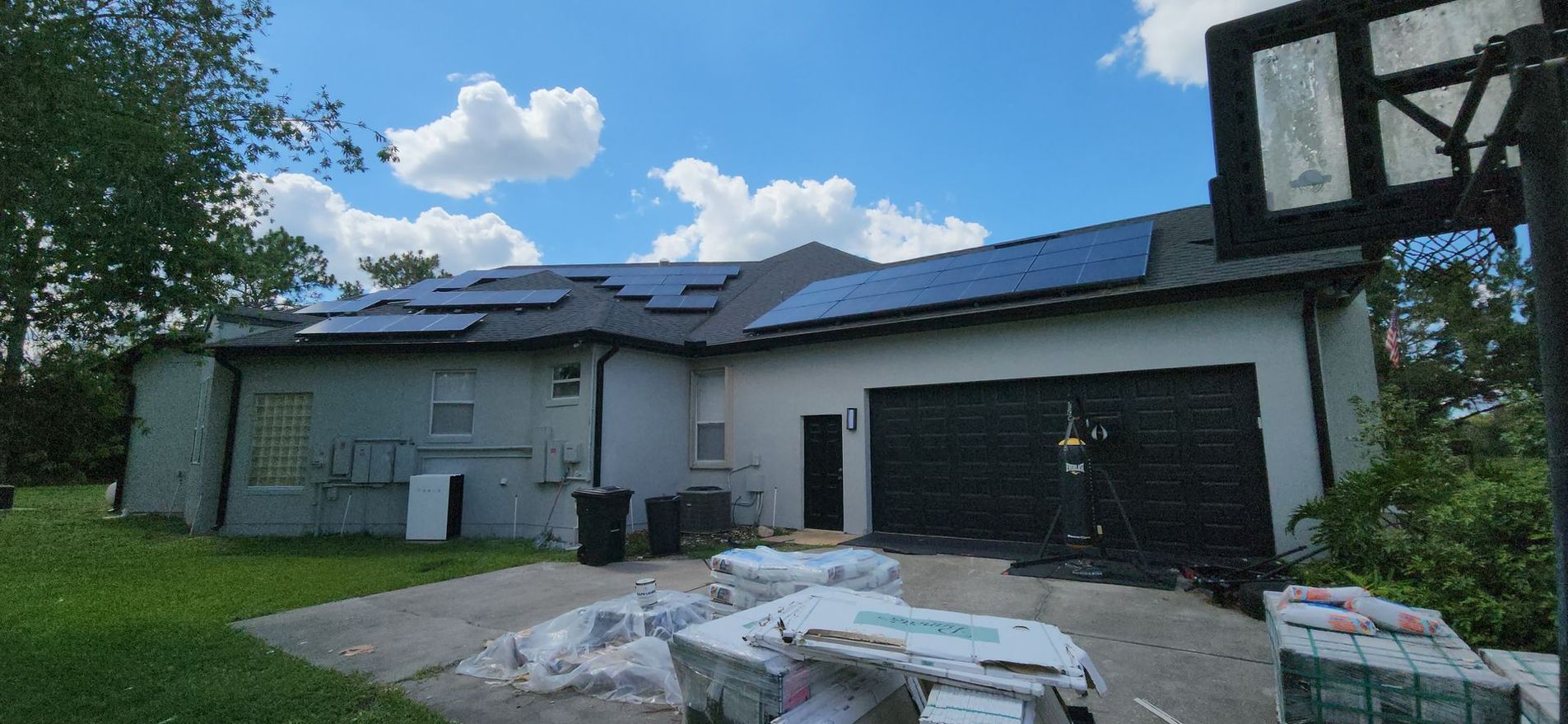 A house with solar panels on the roof is being painted.