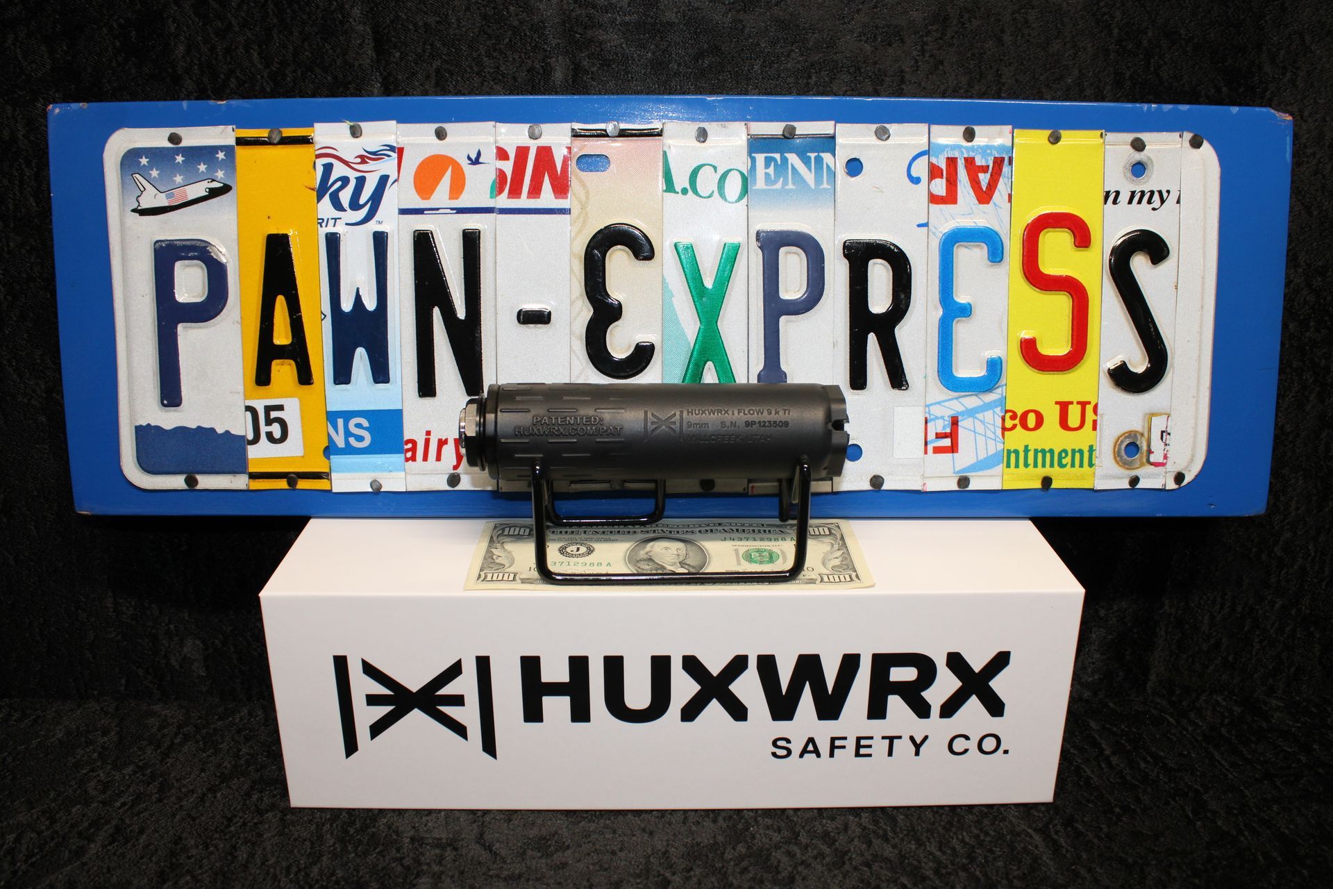 Penn-Express license plate above Huxwrx Safety Co. plate on a blue background