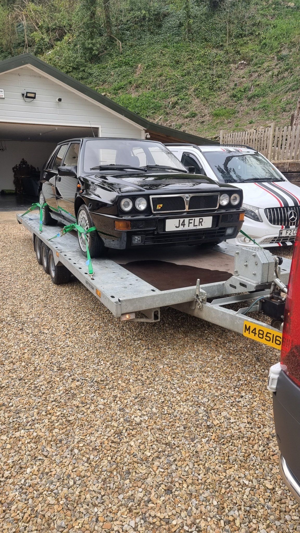A Lancia HF on a trailer towed by a Mercedes Sprinter, ready for transport  by MTC Transport