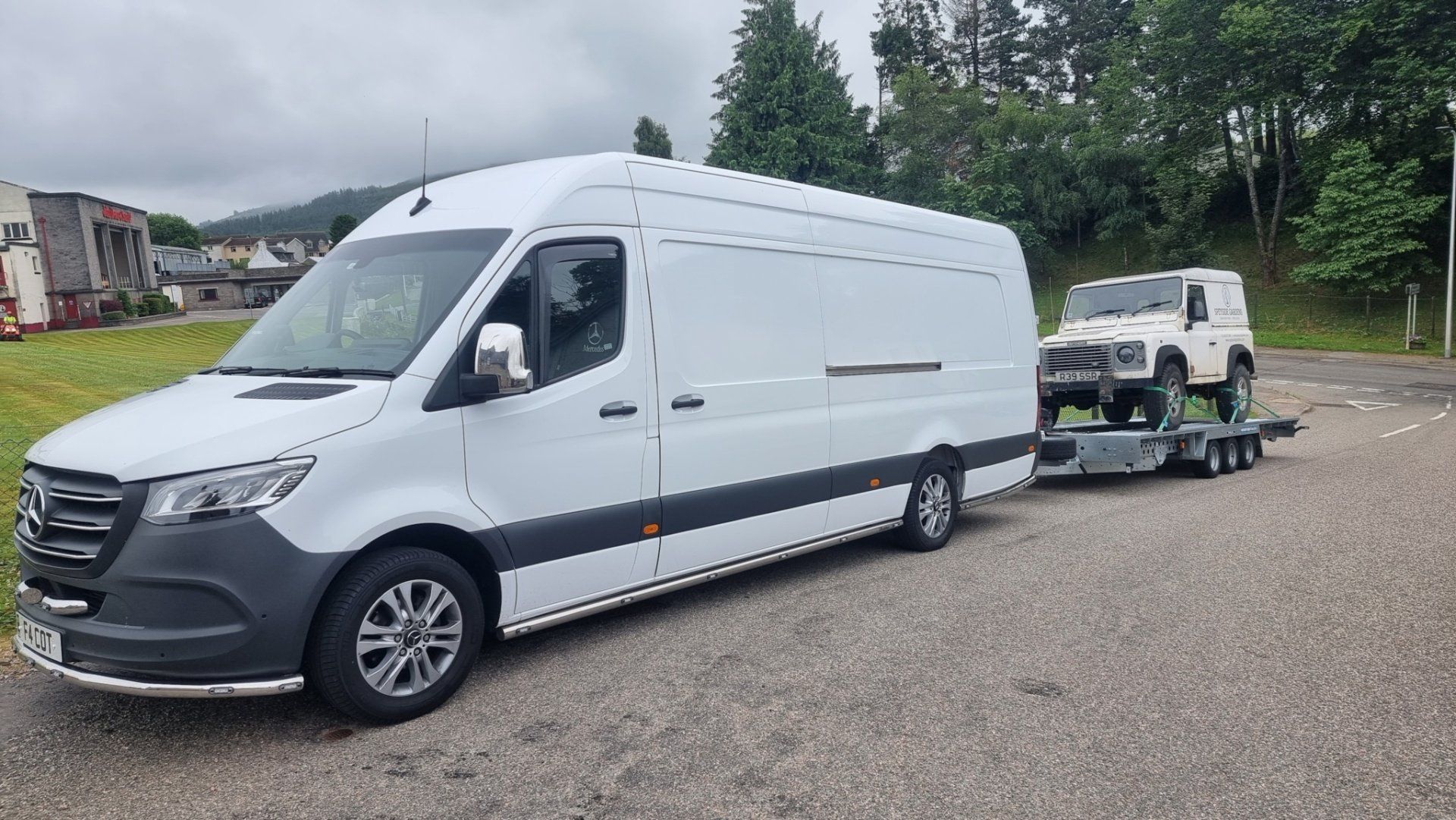 A classic Landrover on a trailer towed by a Mercedes Sprinter, ready for transport  by MTC Transport