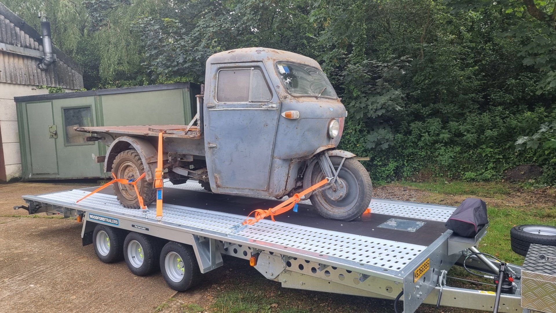 A classic three wheeler on a trailer towed by a Mercedes Sprinter, ready for transport  by MTC Transport